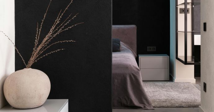 Comfortable soft big bed and small wooden bedside table with carpet in bedroom