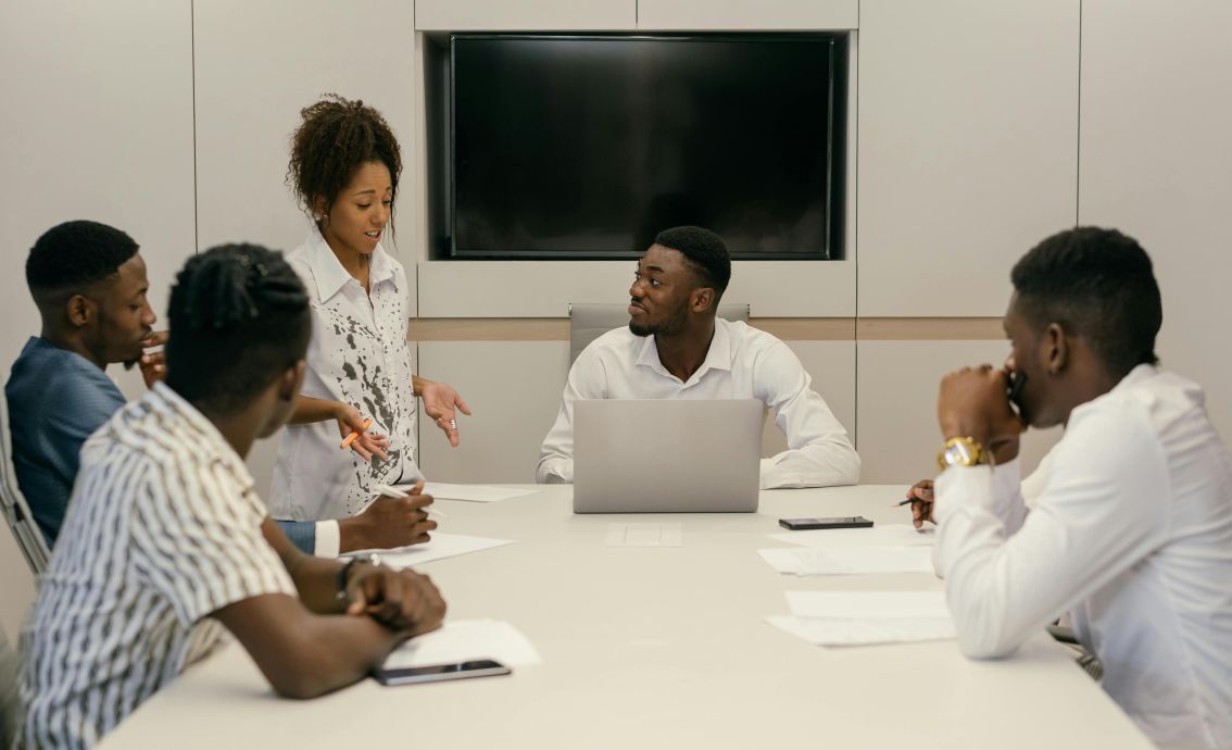 A diverse team of professionals collaborating in a modern office meeting environment.
